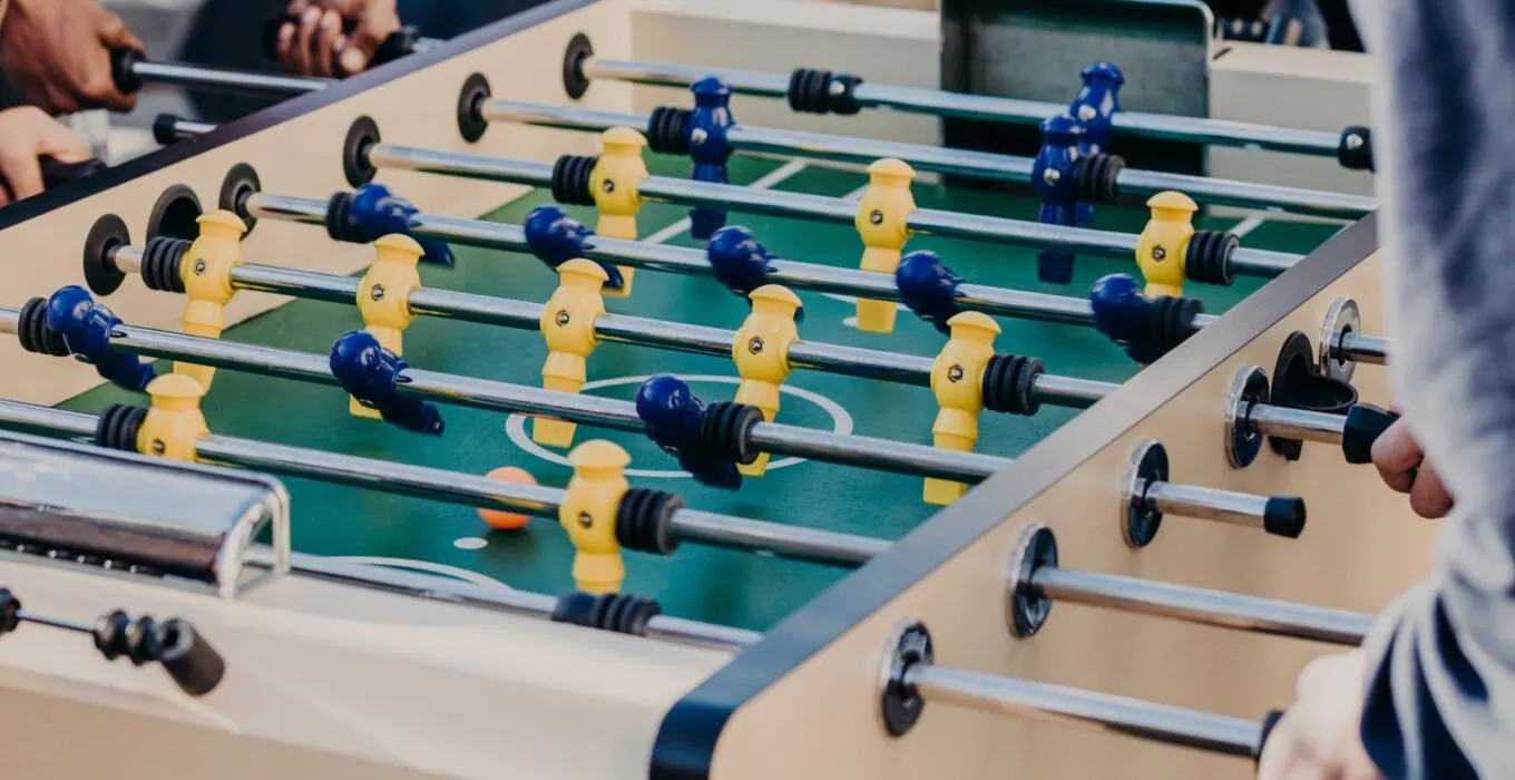 friends play table football game spend free time 2022 04 01 06 04 55 utc